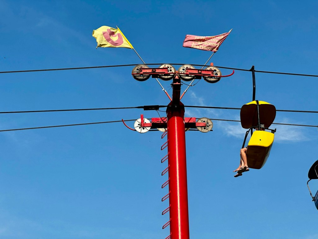 The Sky Glider chairlift over the Summerfest grounds on Milwaukee's lakefront against a blue sky