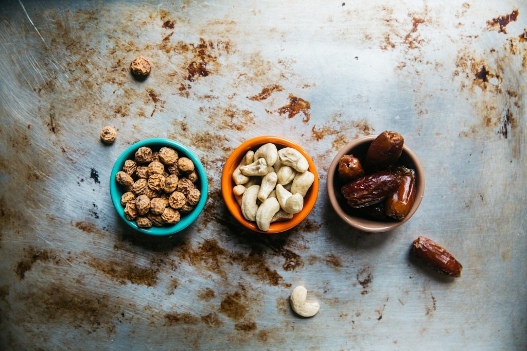 Three bowls of mixed nuts on a table, a simple travel-day snack