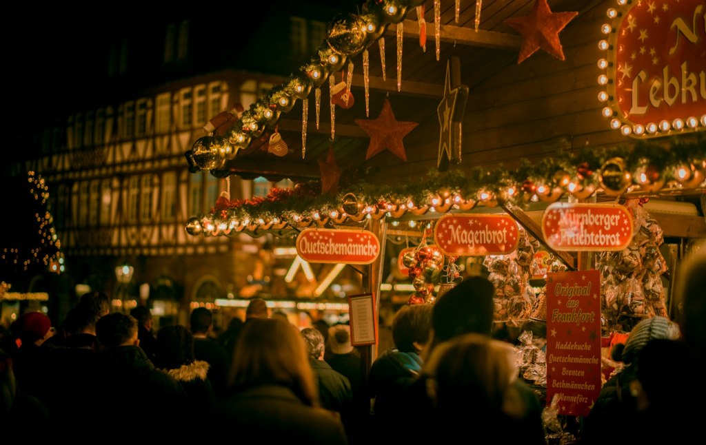 A gingerbread and sweets stall decorated with lights at a German-style Christmas market