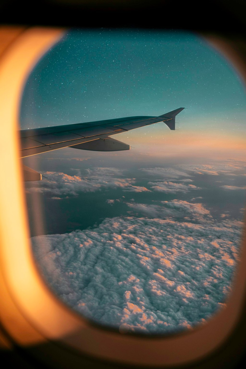 View of white clouds through an airplane window