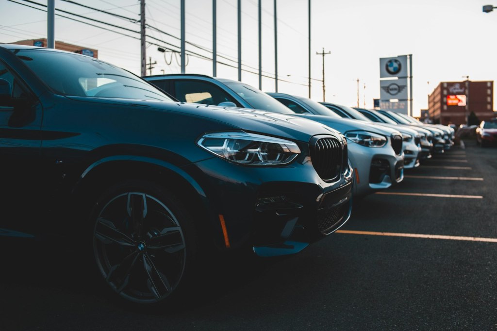 A row of cars parked side by side in a parking lot