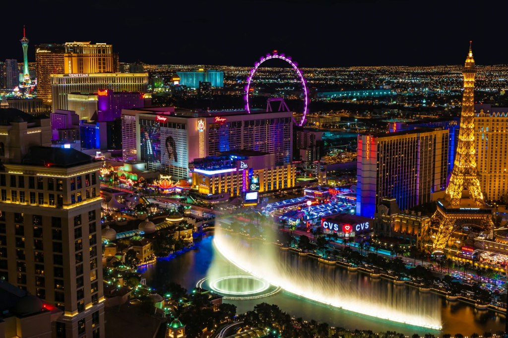 The Las Vegas Strip lit up at night, with the Bellagio fountains and Strip resorts