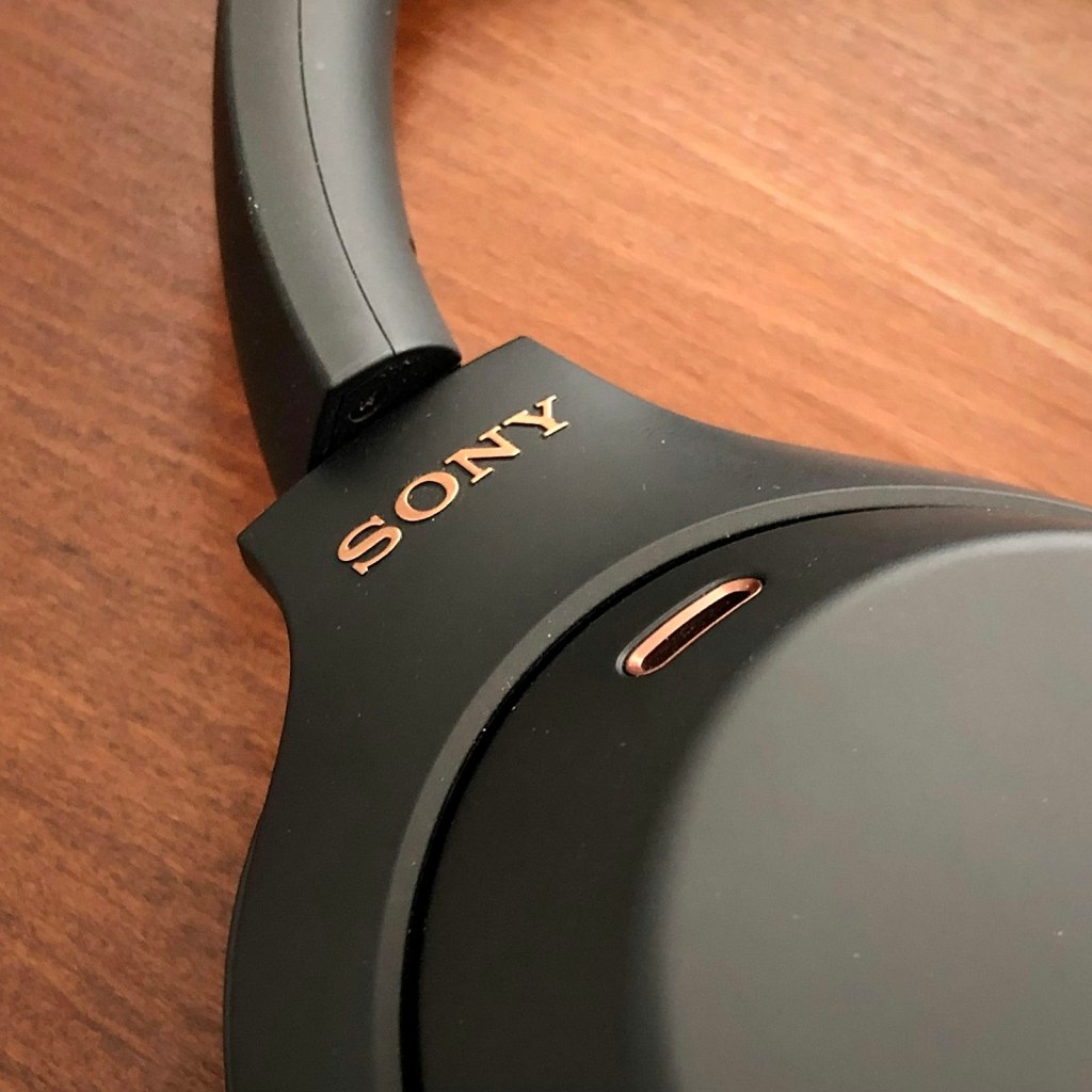 Black Sony noise-canceling headphones on a wooden table