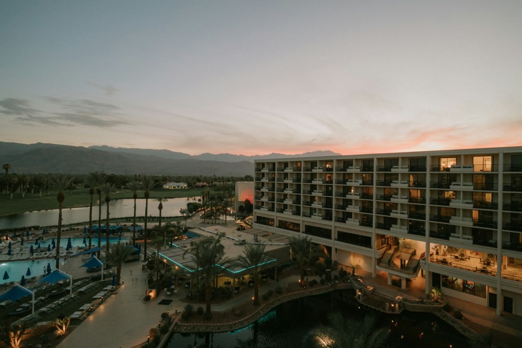 Resort hotel building with a large swimming pool in front
