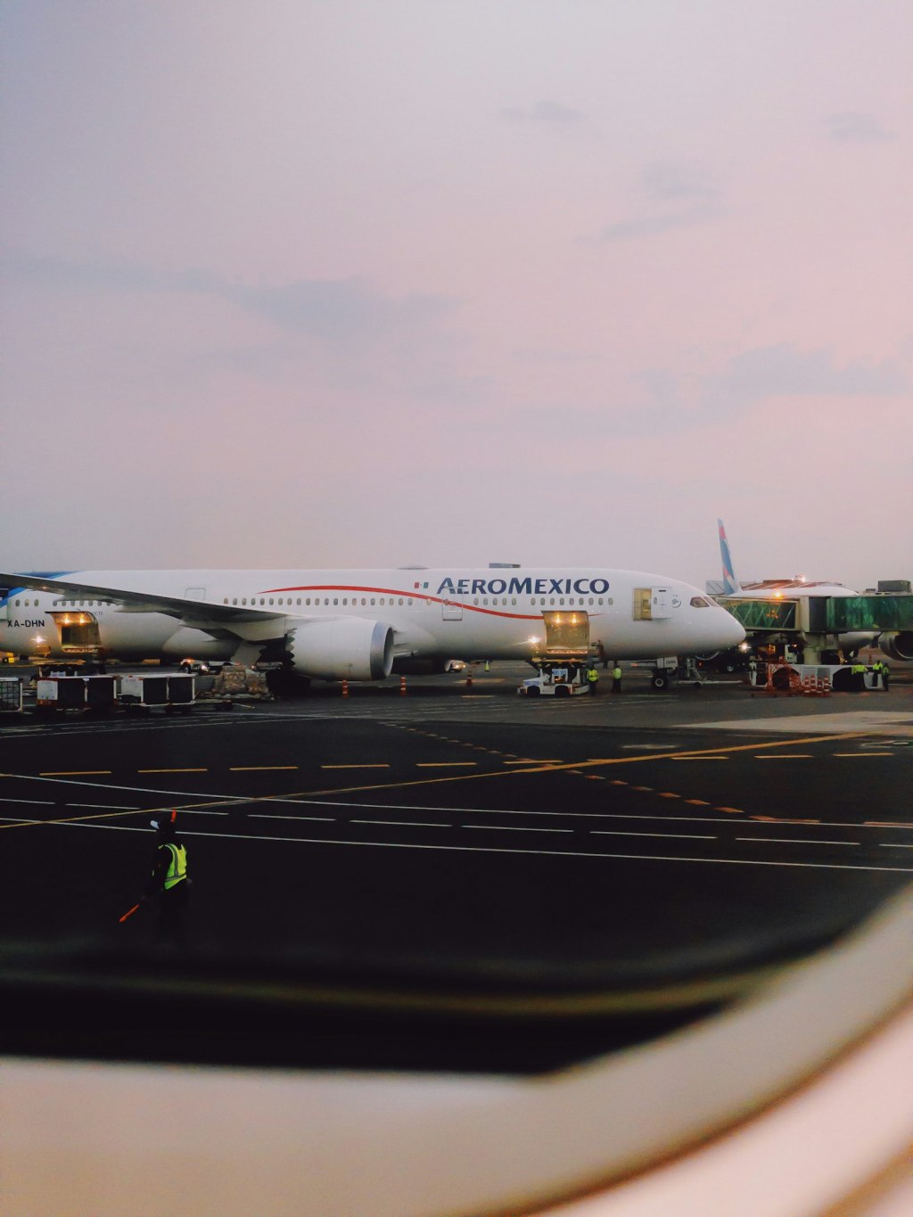 A passenger jet parked on the tarmac at Mexico City International Airport