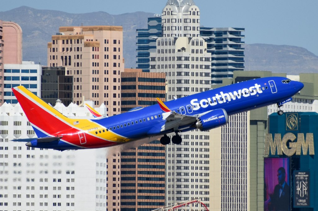 A Southwest Airlines jet flying over a city