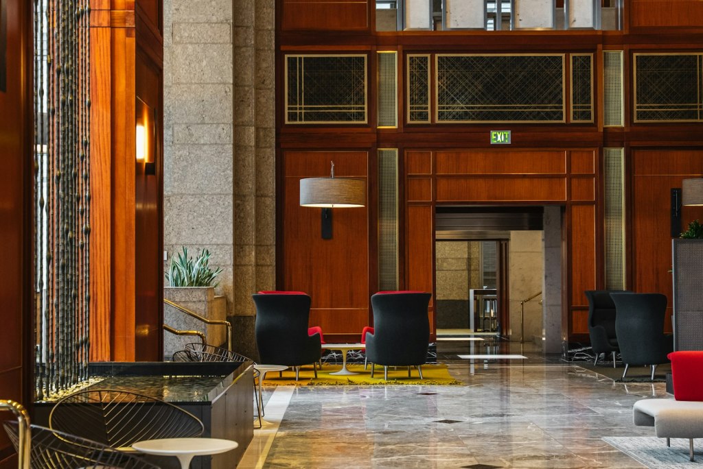 Elegant hotel lobby with modern seating and wood-paneled walls