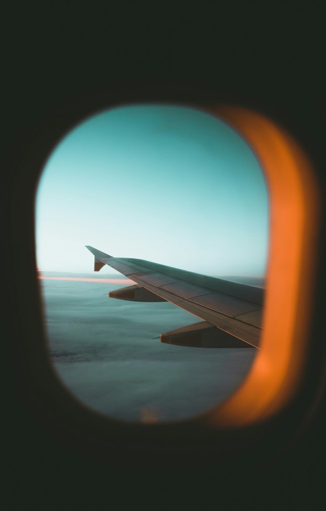 An airplane wing seen through a cabin window