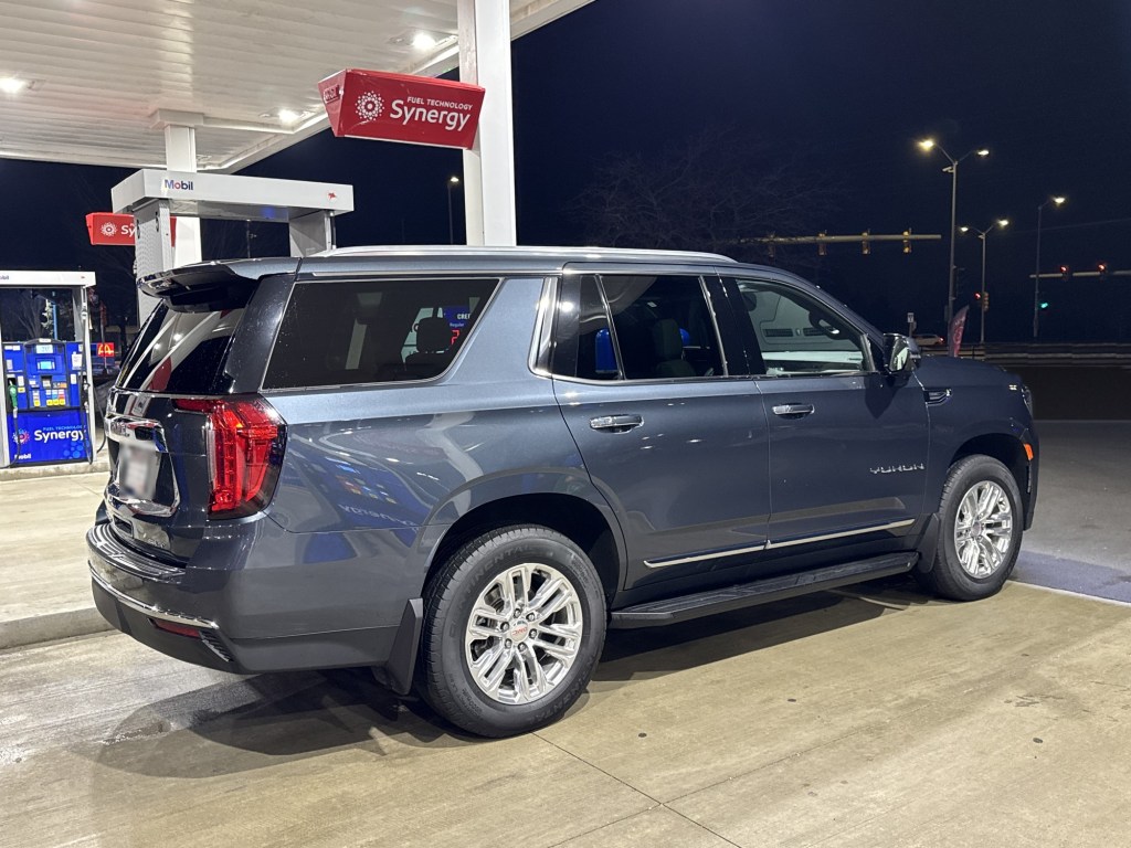Gray 2021 GMC Yukon at a gas station at night