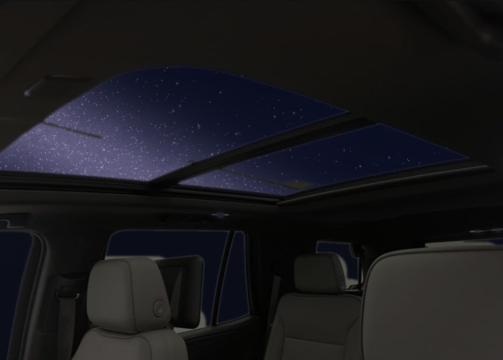 View up through a GMC Yukon panoramic sunroof at a starry night sky