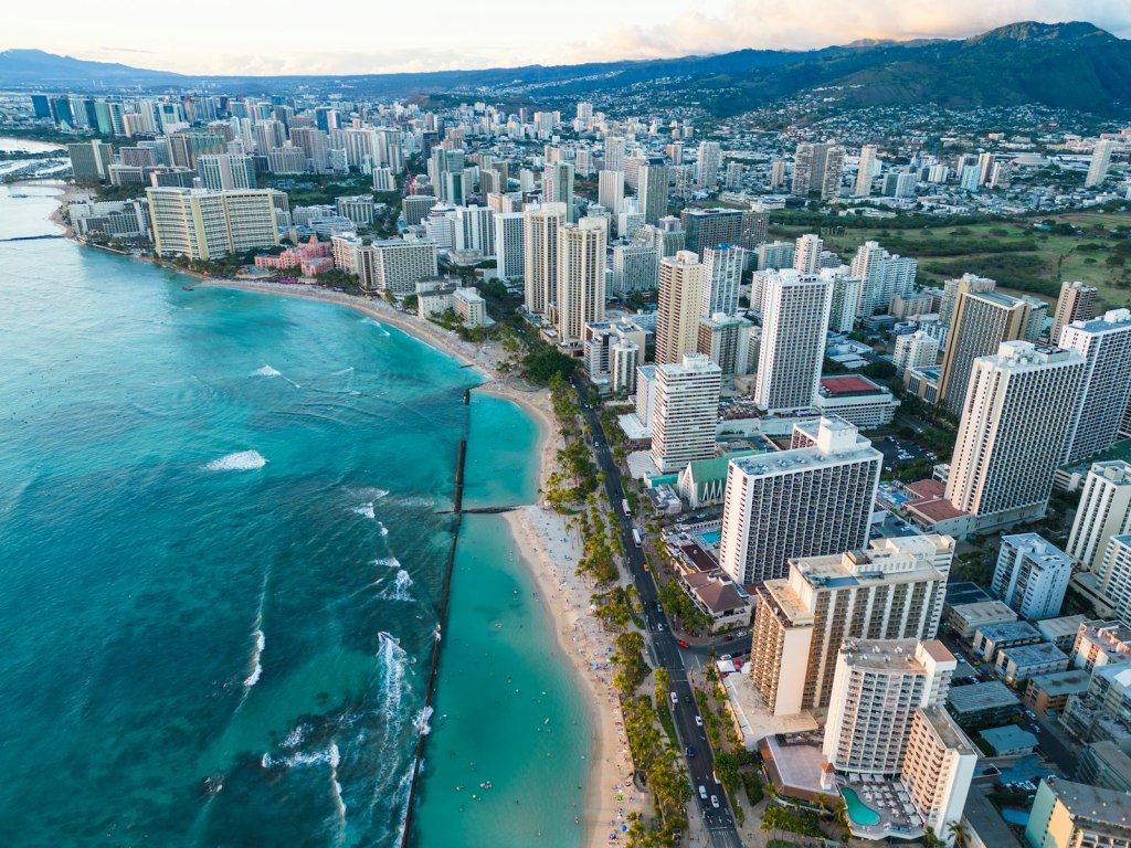 Aerial view of Waikiki's hotel-lined shoreline in Honolulu next to the ocean